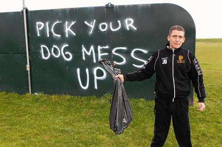 Leysdown FC groundsman John Osmond with a bag of dog poo picked up from the pitch