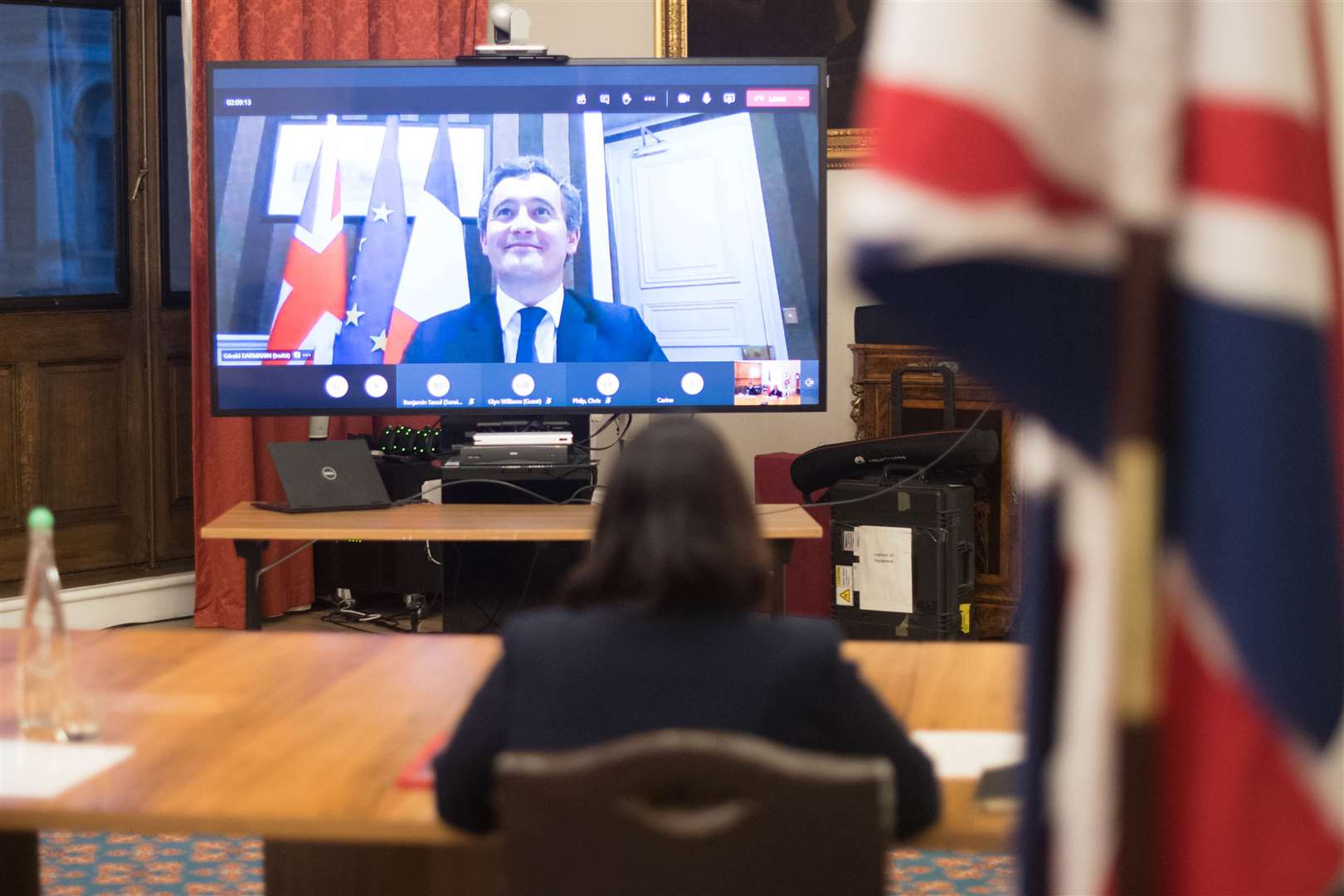Home Secretary Priti Patel with her French counterpart Gerald Darmanin (on screen) (Stefan Rousseau/PA)