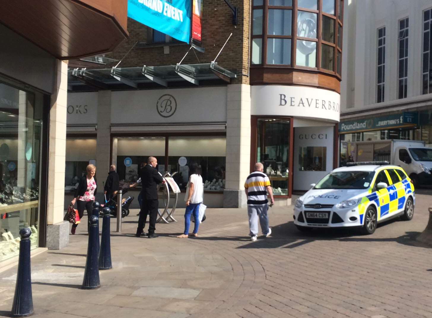 Police at the entrance of Fremlin Walk, which has a number of jewellery shops