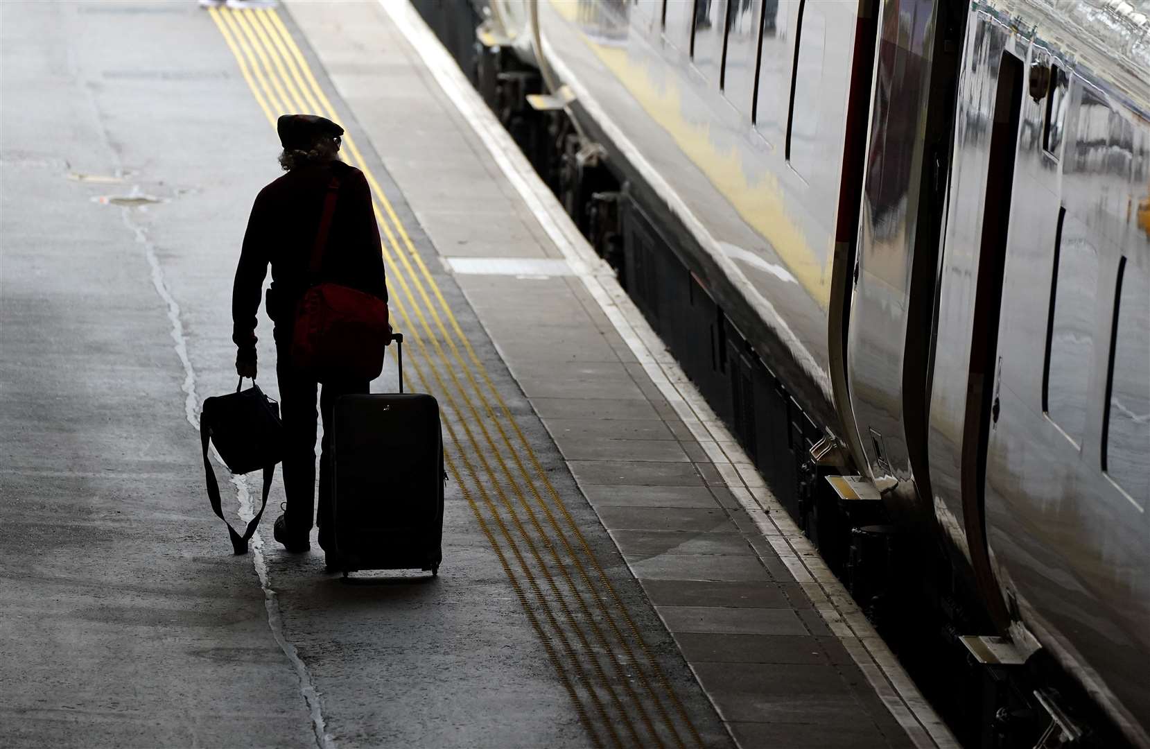 A passenger walks along a platform at Waverley station in Edinburgh (Andrew Milligan/PA)