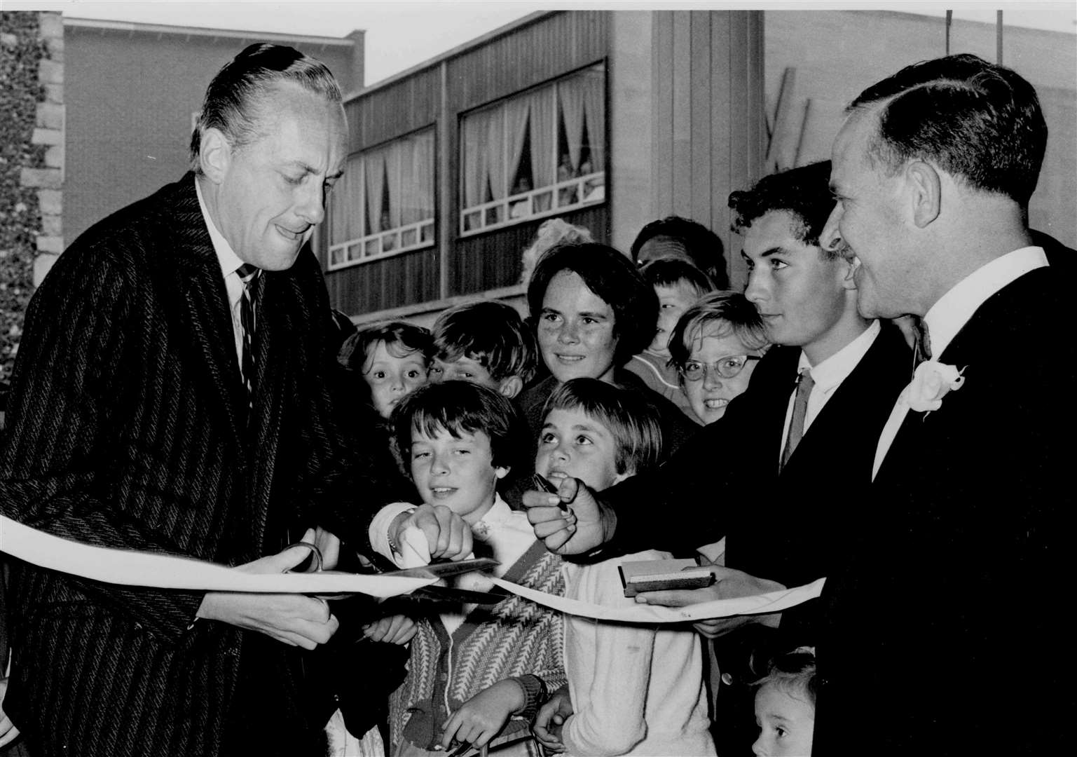 TV personality Hughie Green opens an exhibition of furniture and household equipment at Jays Furnishing Stores, St George's Street, Canterbury, in September 1961. Police controlled a 'huge crowd' which blocked the pavements on both sides of the street for half an hour before he arrived