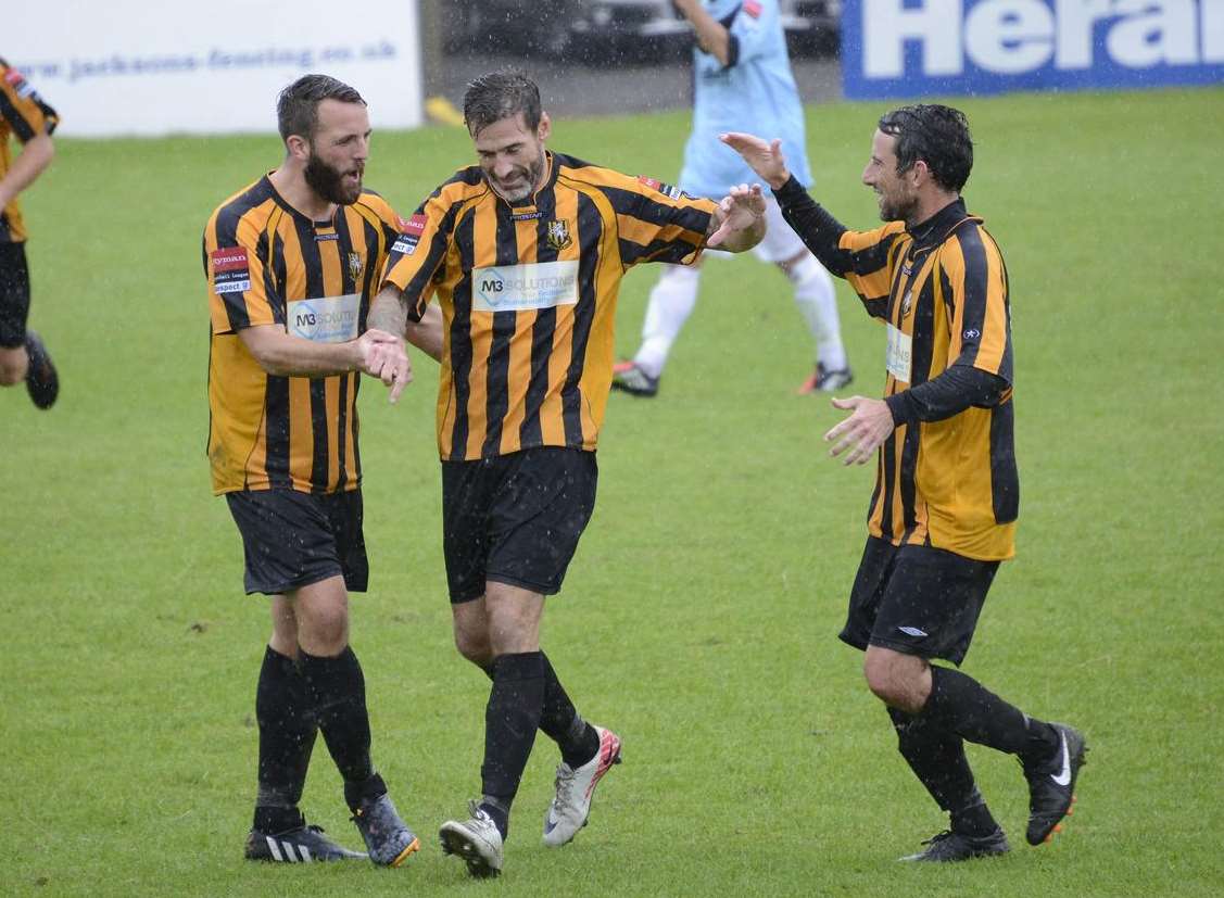 Josh Vincent and Darren Smith congratulate Paul Booth on his goal against Sittingbourne Picture: Paul Amos