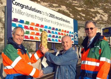 Freight driver Derek Cavanagh receives a bottle of Champagne from director of port operations Philip Dodridge (left) and director of finance Richard Wilcox