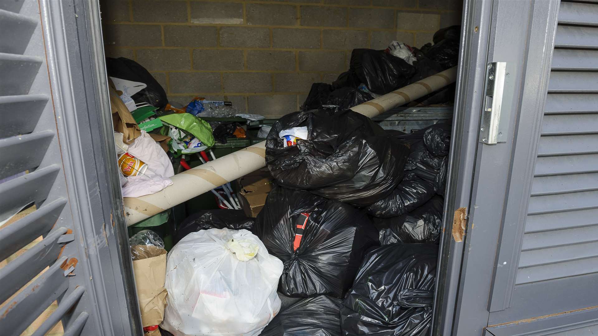The bin store is filling with black sacks after a month of abandoned waste collections