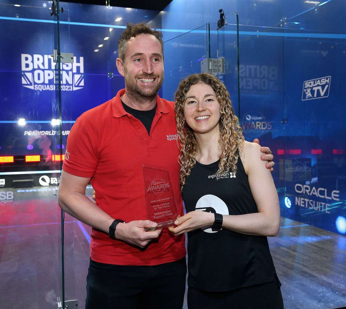 Biddenden Squash Club coach Tom Swain receives the England Squash Club-of-the-Year award from Commonwealth Games gold medallist Gina Kennedy