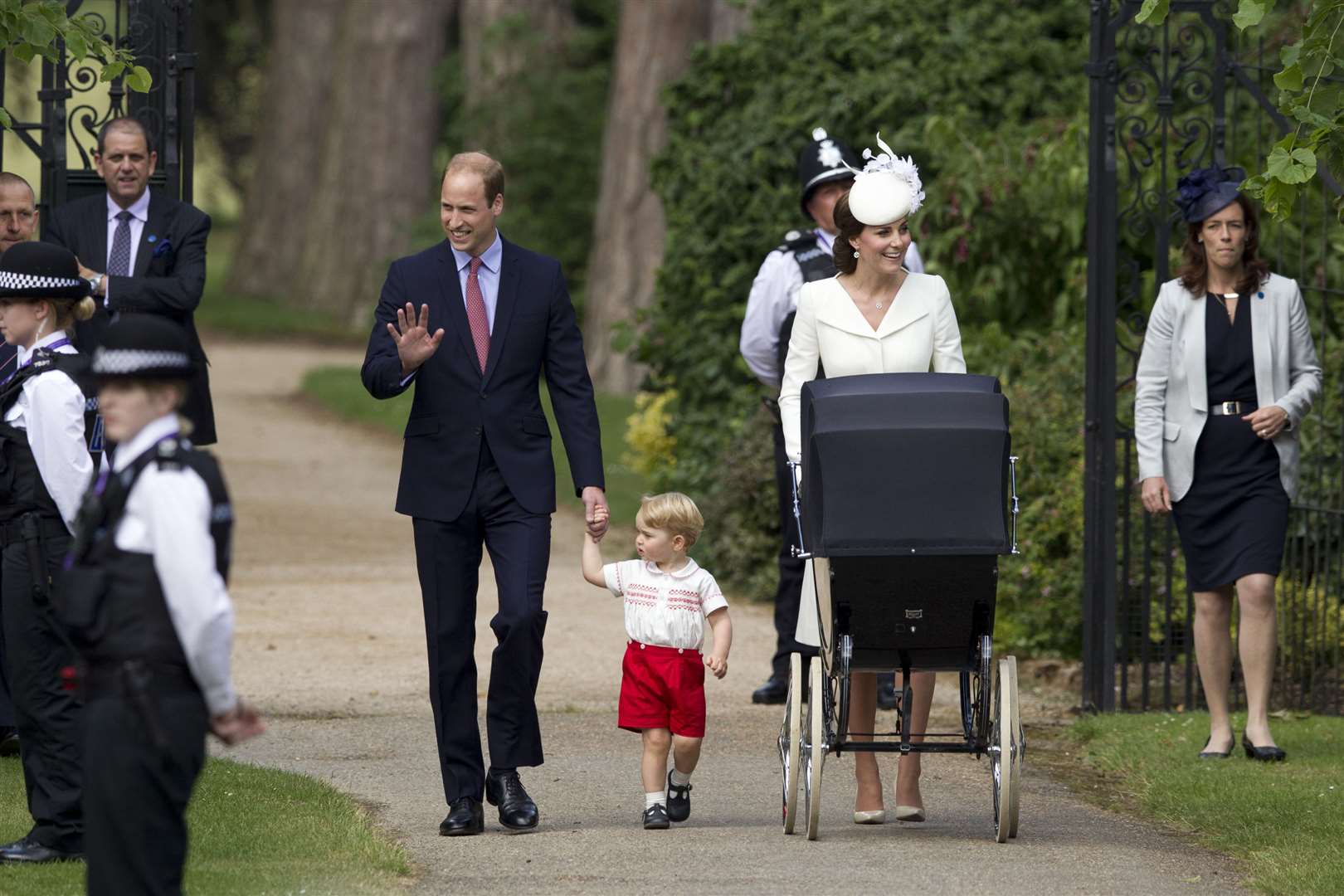 The Duke and Duchess of Cambridge with Prince George and Princess Charlotte in a vintage pram, as they arrive for Charlotte’s christening (Matt Dunham/PA)