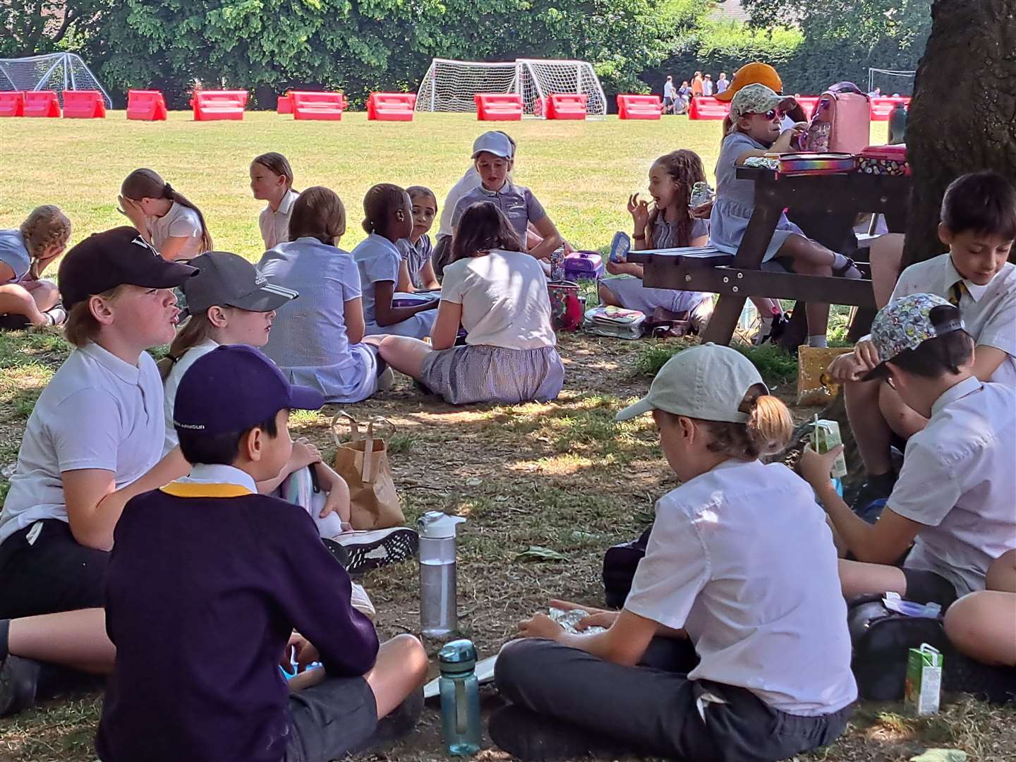 Pupils enjoy a picnic on the school field