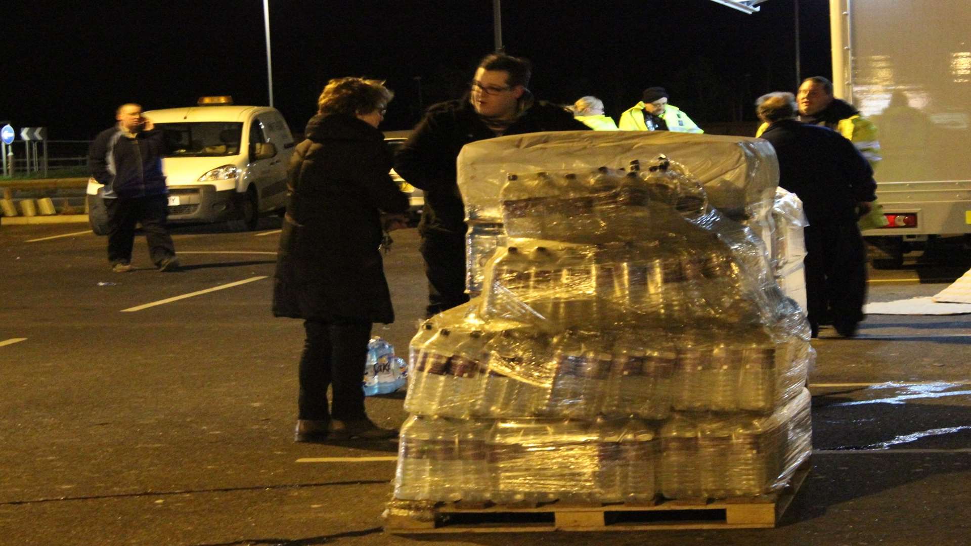 Bottled water being handed out at Morrisons car park, Queenborough