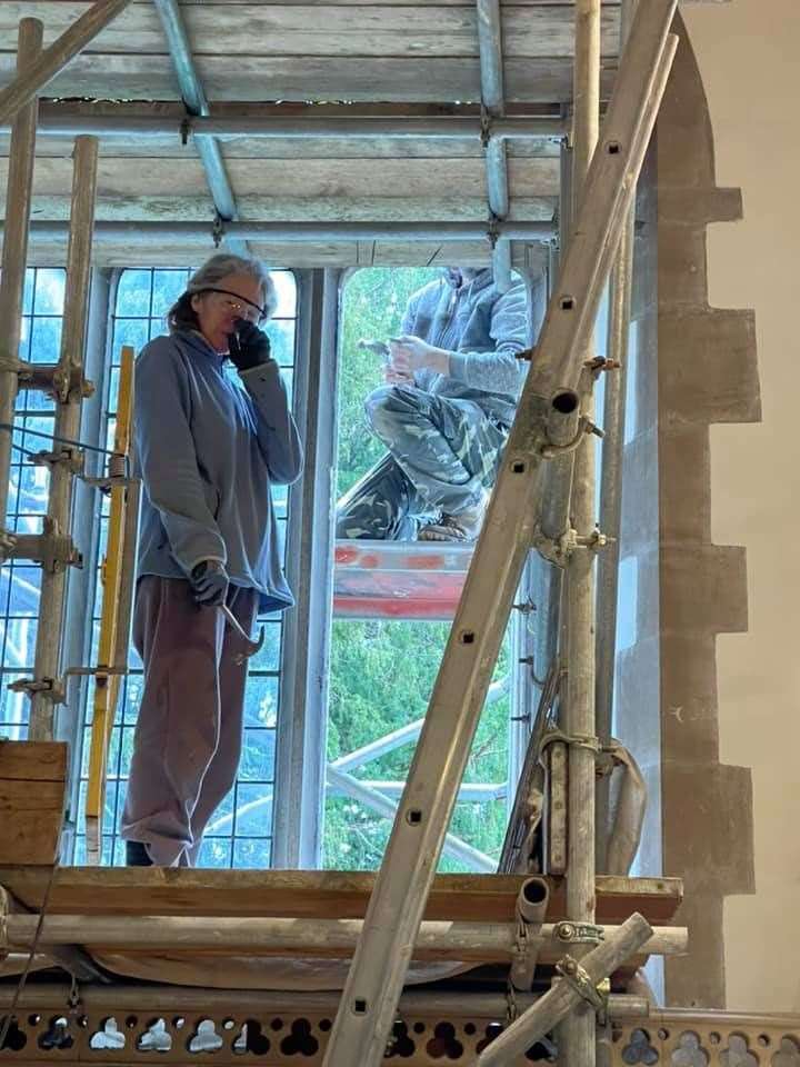 Susan McCarthy of AuraVisions removes the clear glass window at Borden parish church