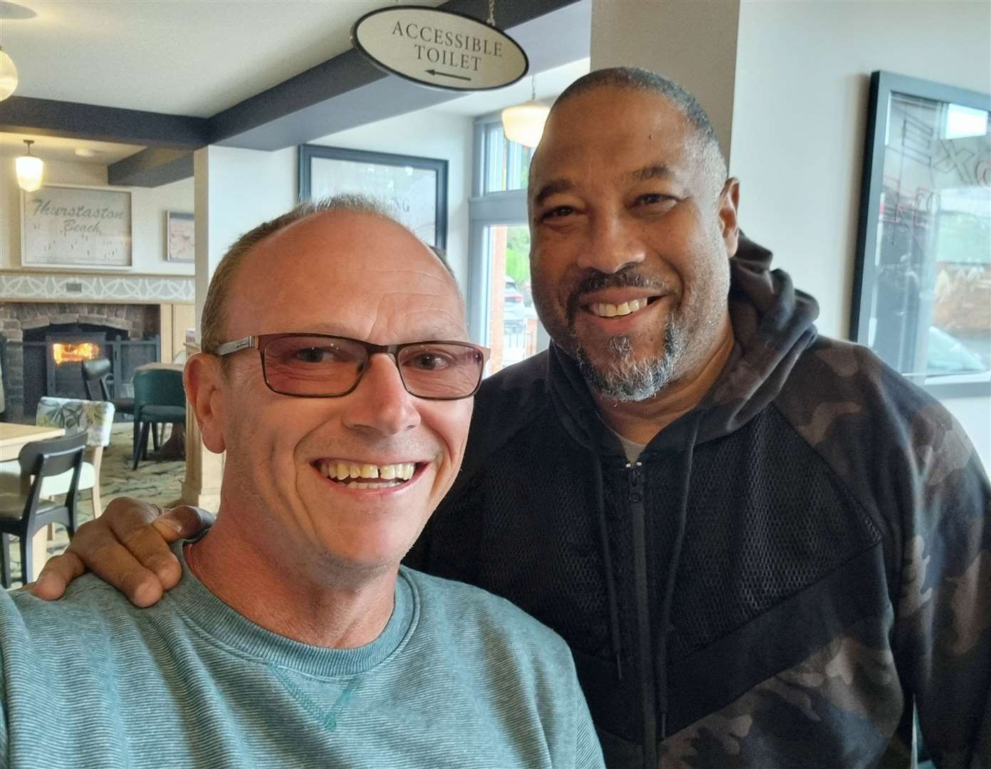 David Bingham with football legend John Barnes in one of the Spoons he’s visited. Picture: SWNS