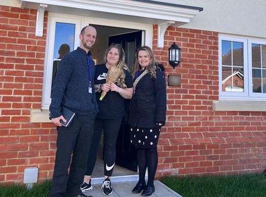 A DDC housing officer handing over the keys to new residents who recently moved into a property in Napchester Road, Whitfield