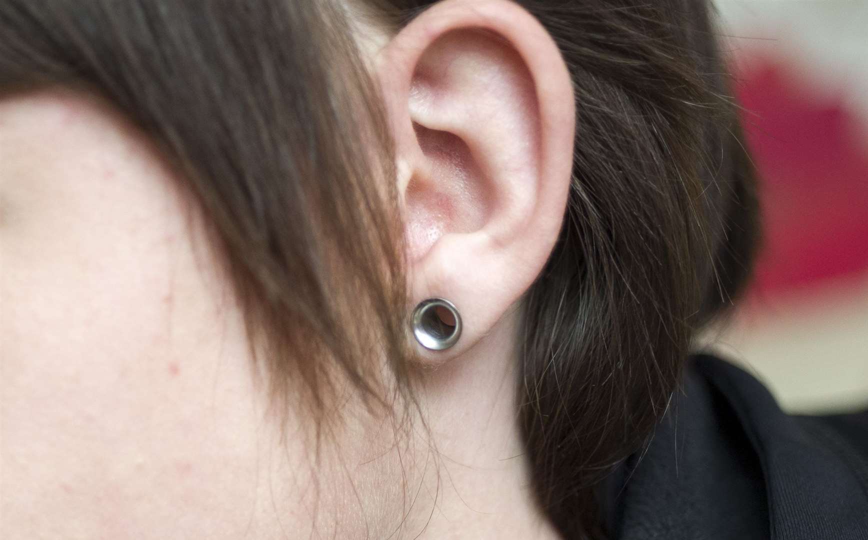 Should police officers be able to wear ear stretching piercings?