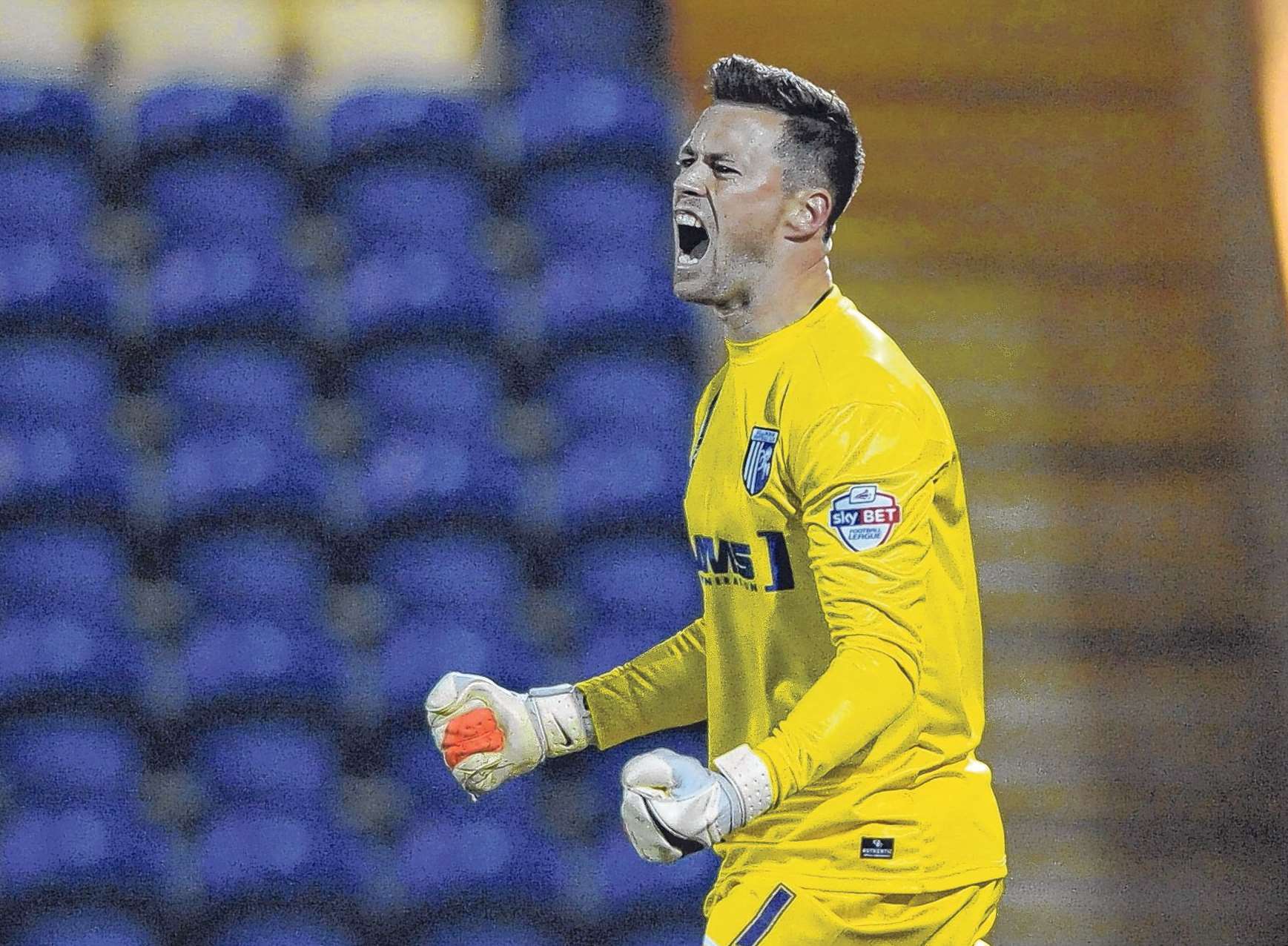 Stuart Nelson celebrates one of two penalty saves against Colchester Pic: Barry Goodwin
