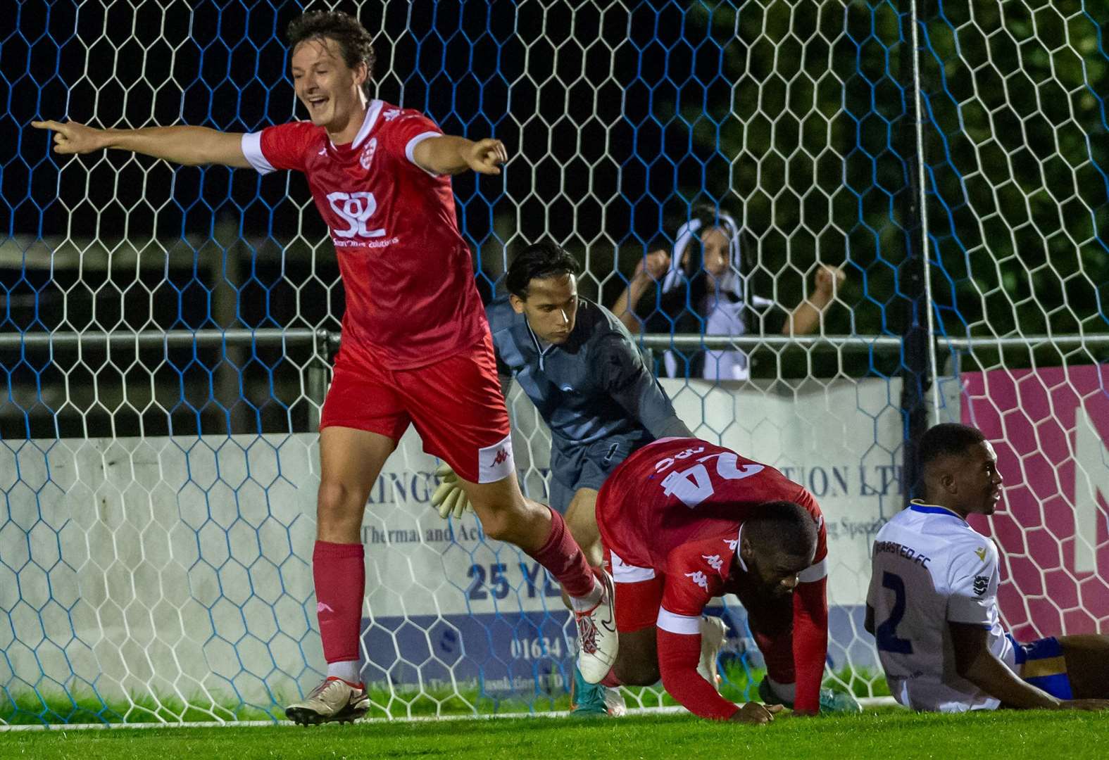 Billy Bennett celebrates after doubling Faversham's lead in their 2-1 triumph against Bearsted on Tuesday as Bears keeper Frankie Leonard and defender Dennis Agbudume are left on the floor. Picture: Ian Scammell