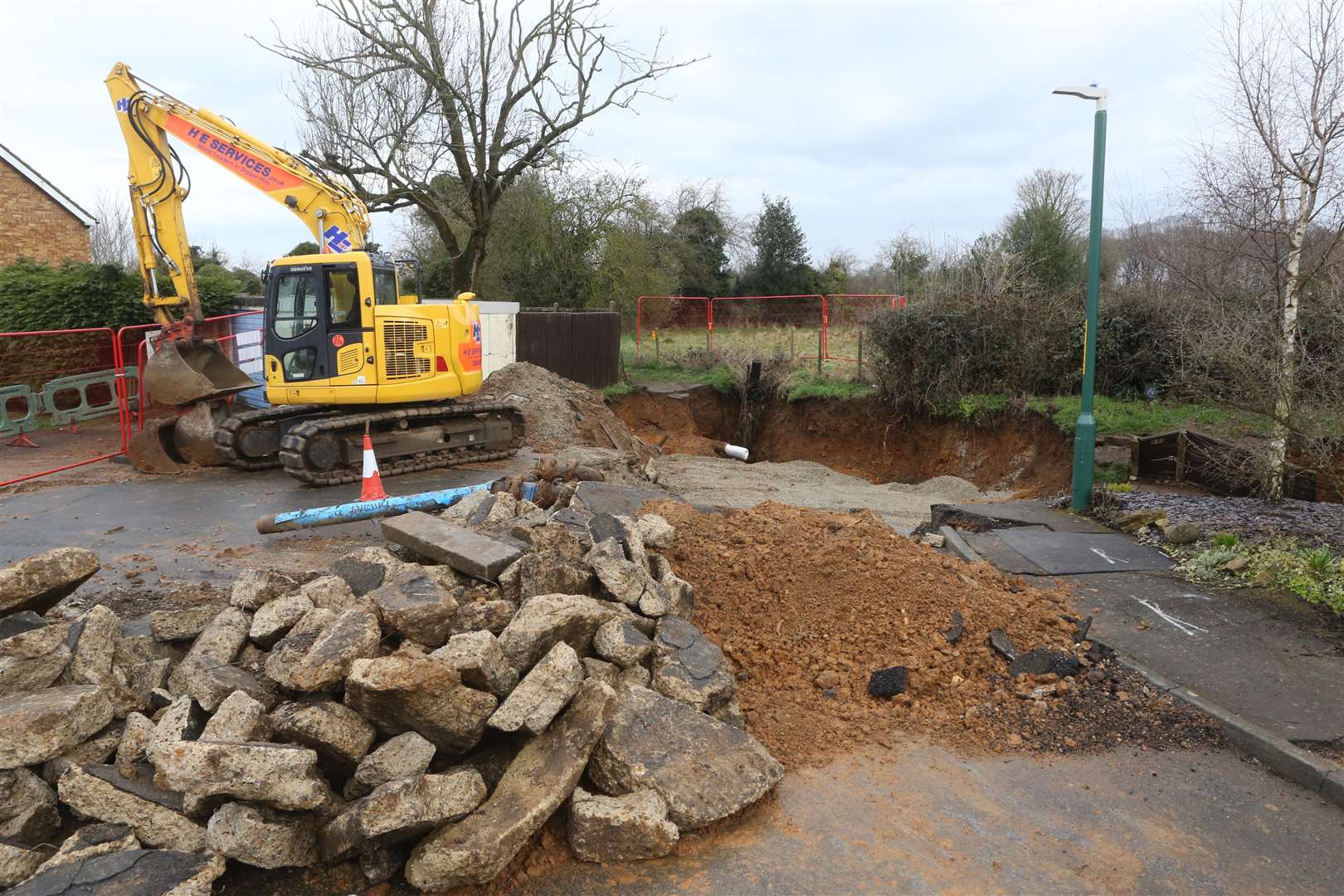 A digger marks the area where a large and deep sink hole has appeared at the end of Broomshaw Road where it meets Wesley Road on a Barming housing estate. Picture by: John Westhrop. (1366205)