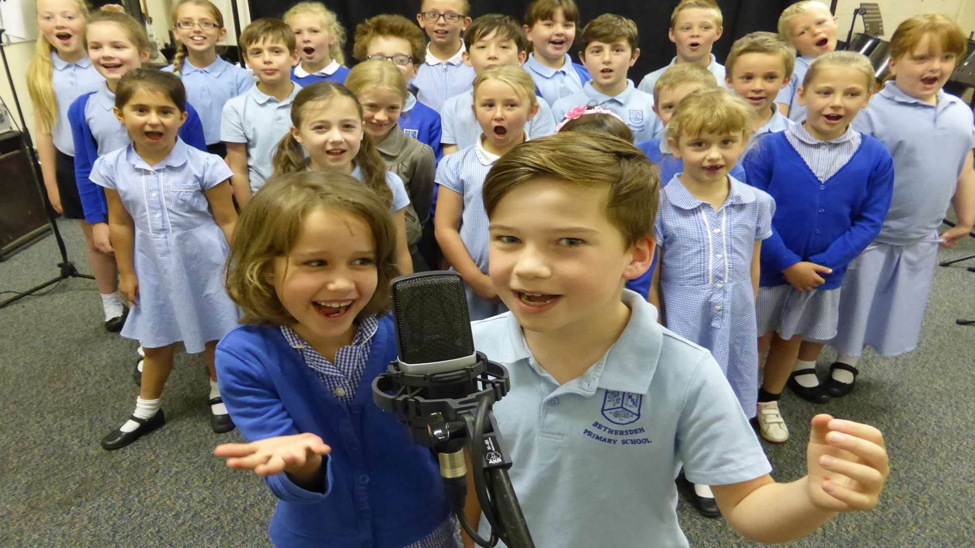 Rhea Carysforth, seven, and Harry Fensome, seven, lead the Bethersden Primary School choir as they record their KM Walk to School Song Contest track in 2015. Entries for this year's contest are now open.