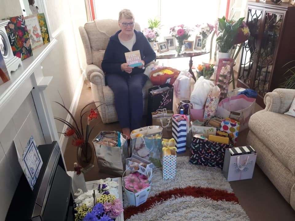 Maureen Pledger surrounded by gifts and messages from people wishing her well