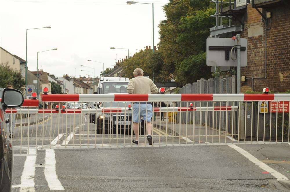 Man jumped the barrier and ran across the track, narrowly avoiding being hit by train at Gillingham railway crossing.