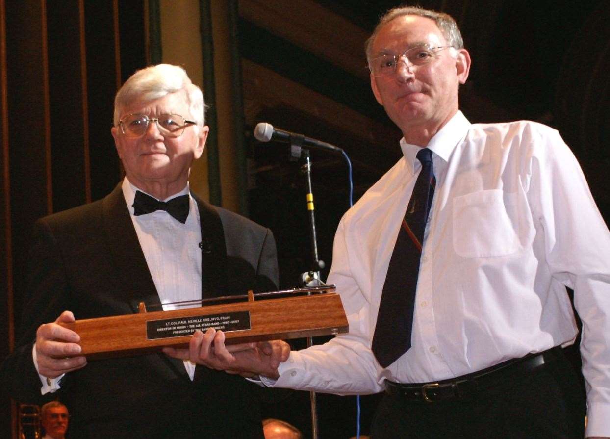 Lt Col Paul Neville receives the silver baton from Steve Misson, organiser, at the 18th All Stars annual concert in 2007. Picture: Steve Misson