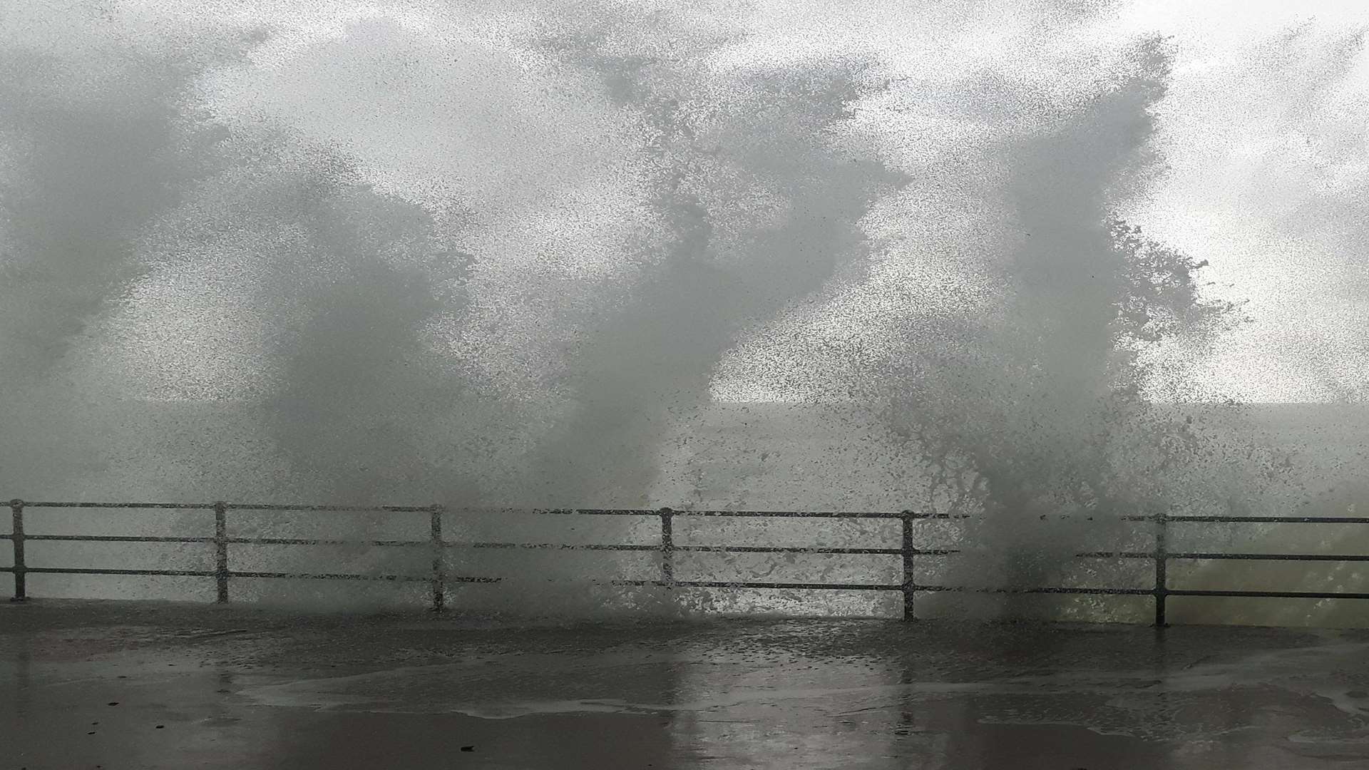 Waves batter the sea wall at Folkestone