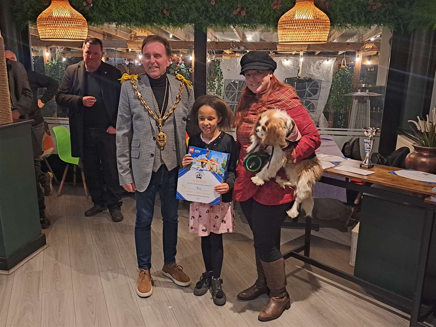 The winner of the T-shirt design competition Nina Mwamdira receives her prize from the Mayor Maidstone Derek Mortimer and committee member Clairey Suzanne, with mascot Peppermint