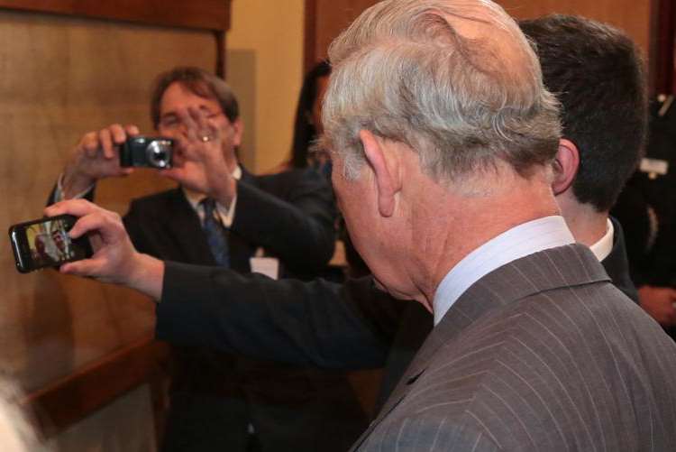 Teenager Joseph Wilson posing for a selfie on his mobile phone with Prince Charles. Picture: Martin Apps