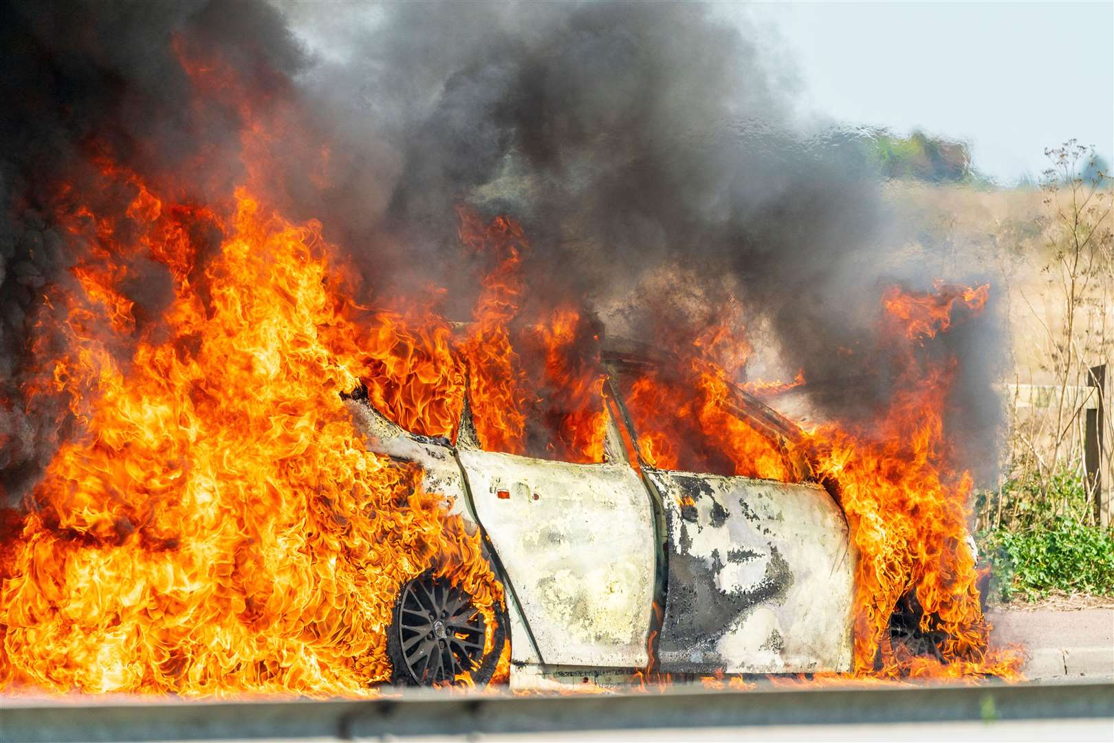 A picture of the car alight shows huge plumes of thick smoke filling the air. Credit: Malcolm Fairman/Alamy Live News