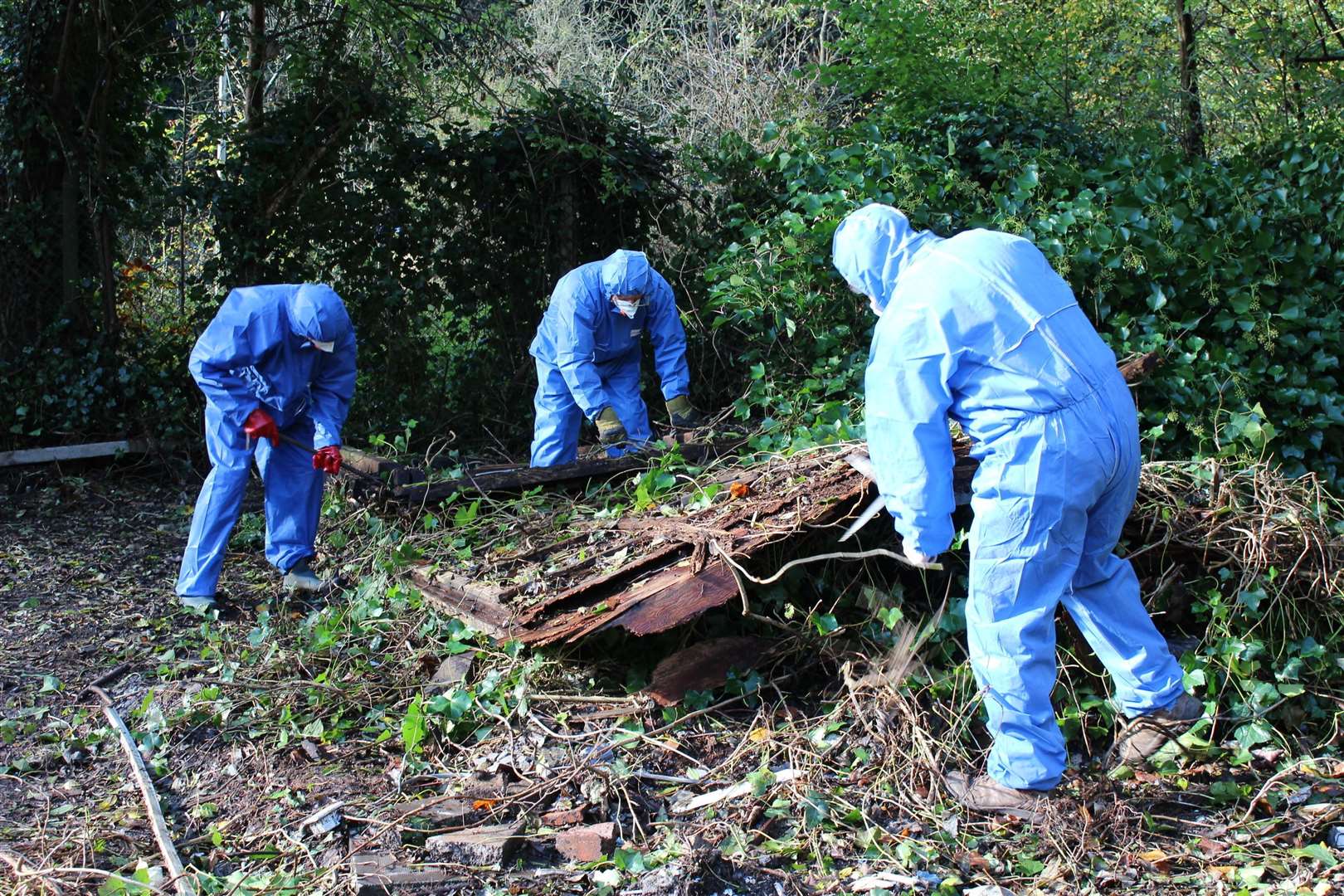 Heavily protected volunteers from the Valley Conservation Society removing asbestos from Crisbrook Meadow in Tovil in 2014