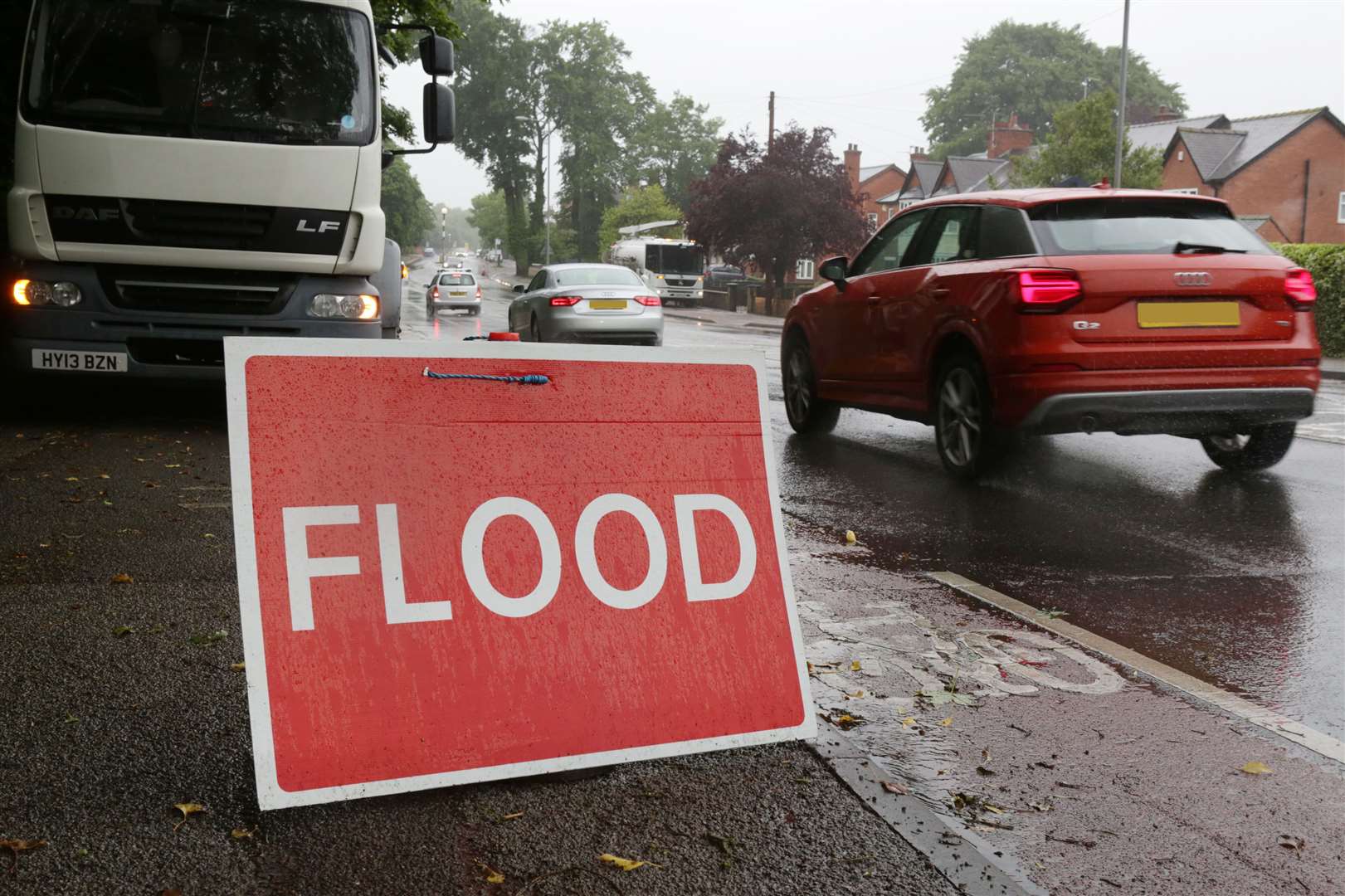 Cars pass through flooding. Stock image