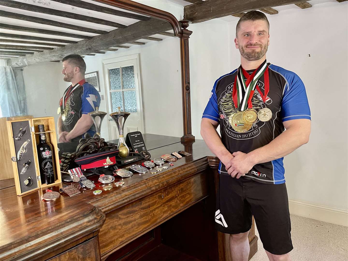 Rob Long, who lives on the outskirts of Canterbury, photographed with his army and jiu-jitsu medals