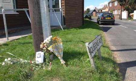 Floral tributes left at the scene of the collision . Picture: GARY BROWNE