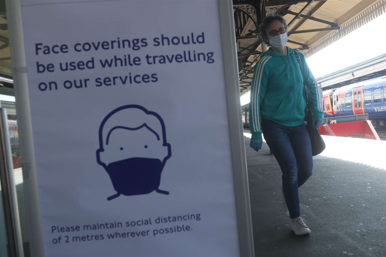 A sign advising passengers to wear a face mask at Clapham Junction station (Yui Mok/PA)