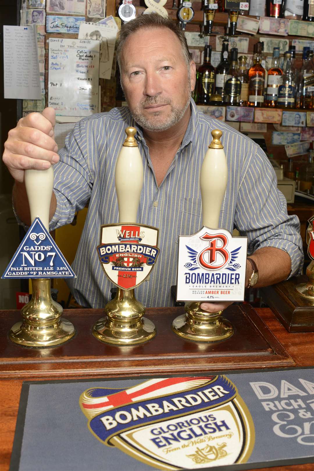 Landlord Kevin Costello is angry that the new branding for Bombardier beer has changed from English beer to British beer. Picture: Paul Amos