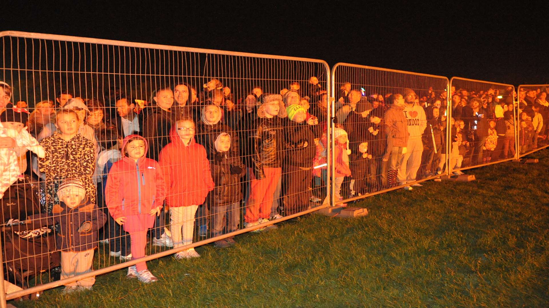 People line the fences to see the bonfire at the 2014 Gillingham Fireworks Display