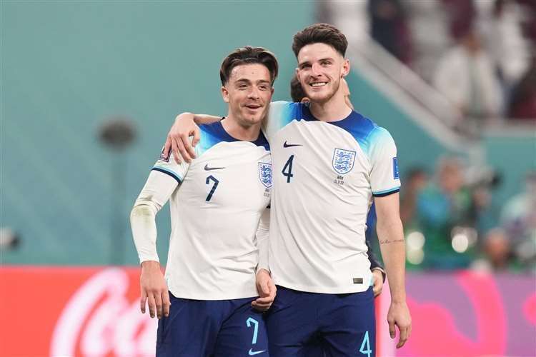 England’s Jack Grealish celebrates with team-mate Declan Rice following their win against Iran. Photo: Martin Rickett/PA.