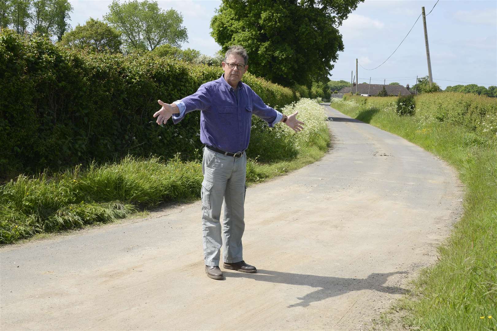 Simon Good shows where the road was blocked by fly-tipping. Picture: Paul Amos