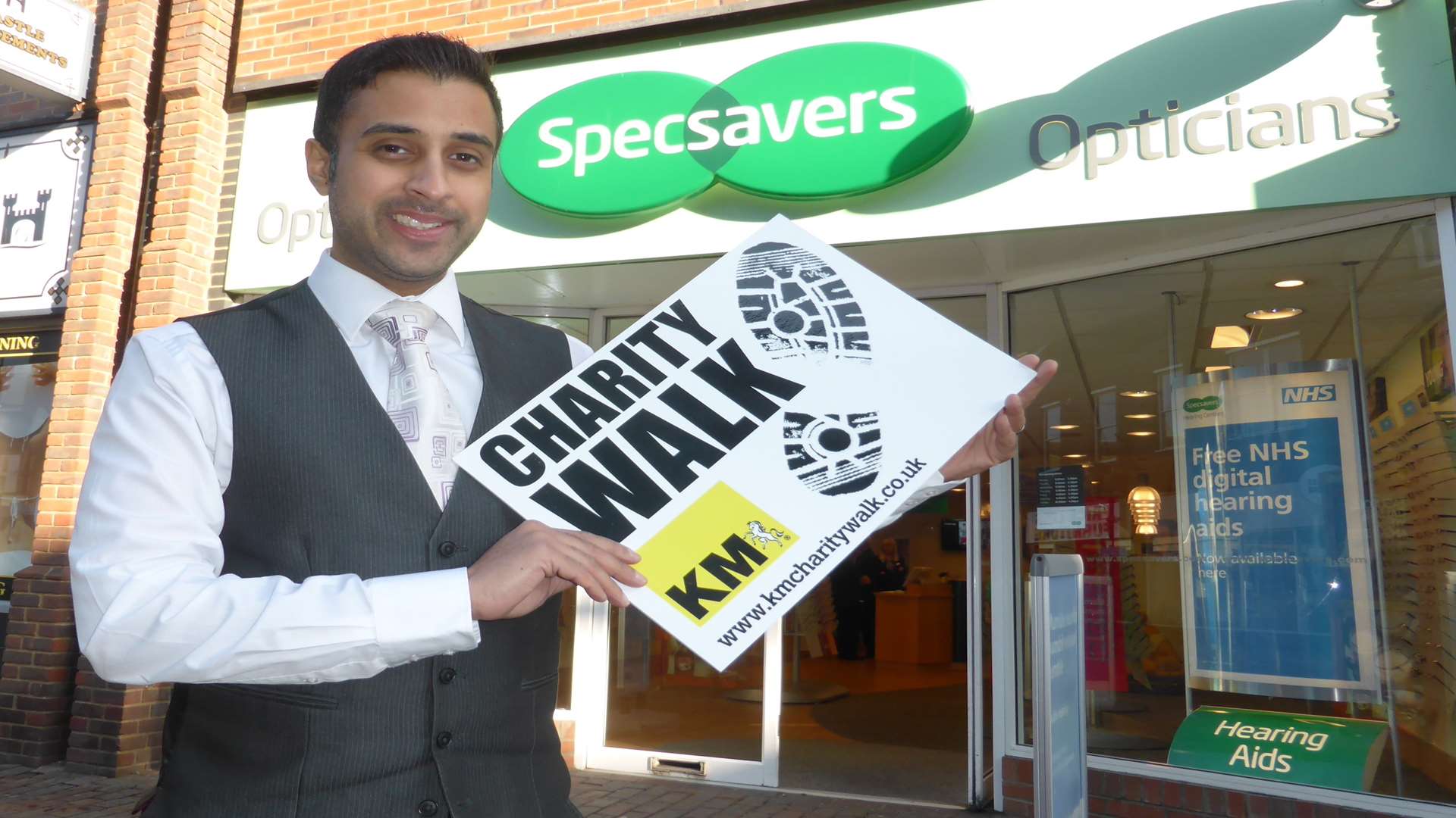 Kent Specsavers spokesman Pritin Patel announces the company's support of the 21st anniversary KM Charity Walk being staged on June 26.
