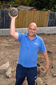 Glen McConnel with the cannonball found in his garden