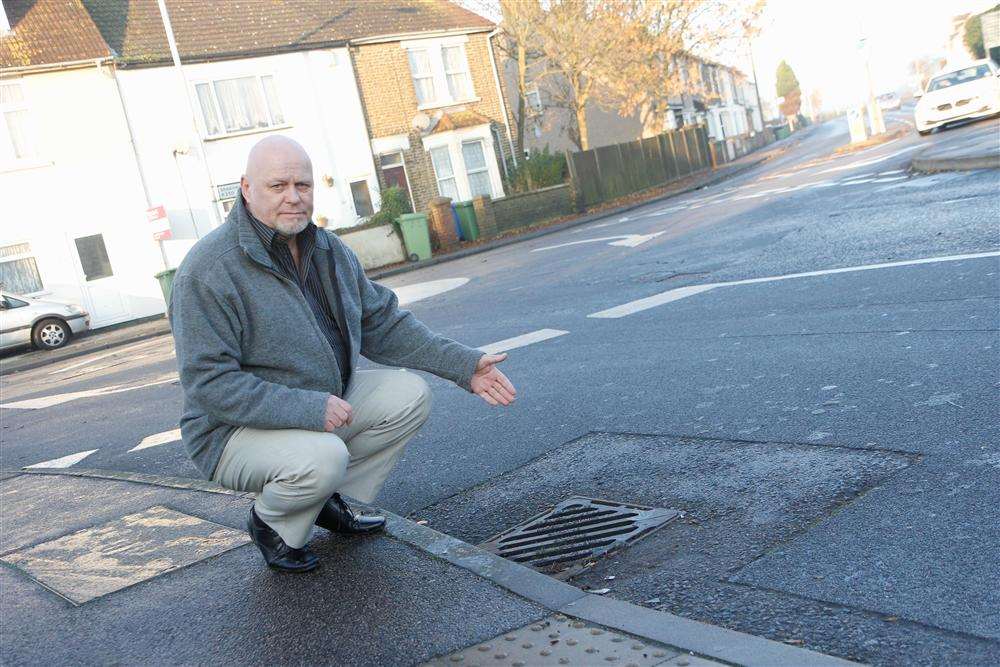 Cllr Mick Constable next to the drain which is being cleared after years of floods caused by a 93% blockage