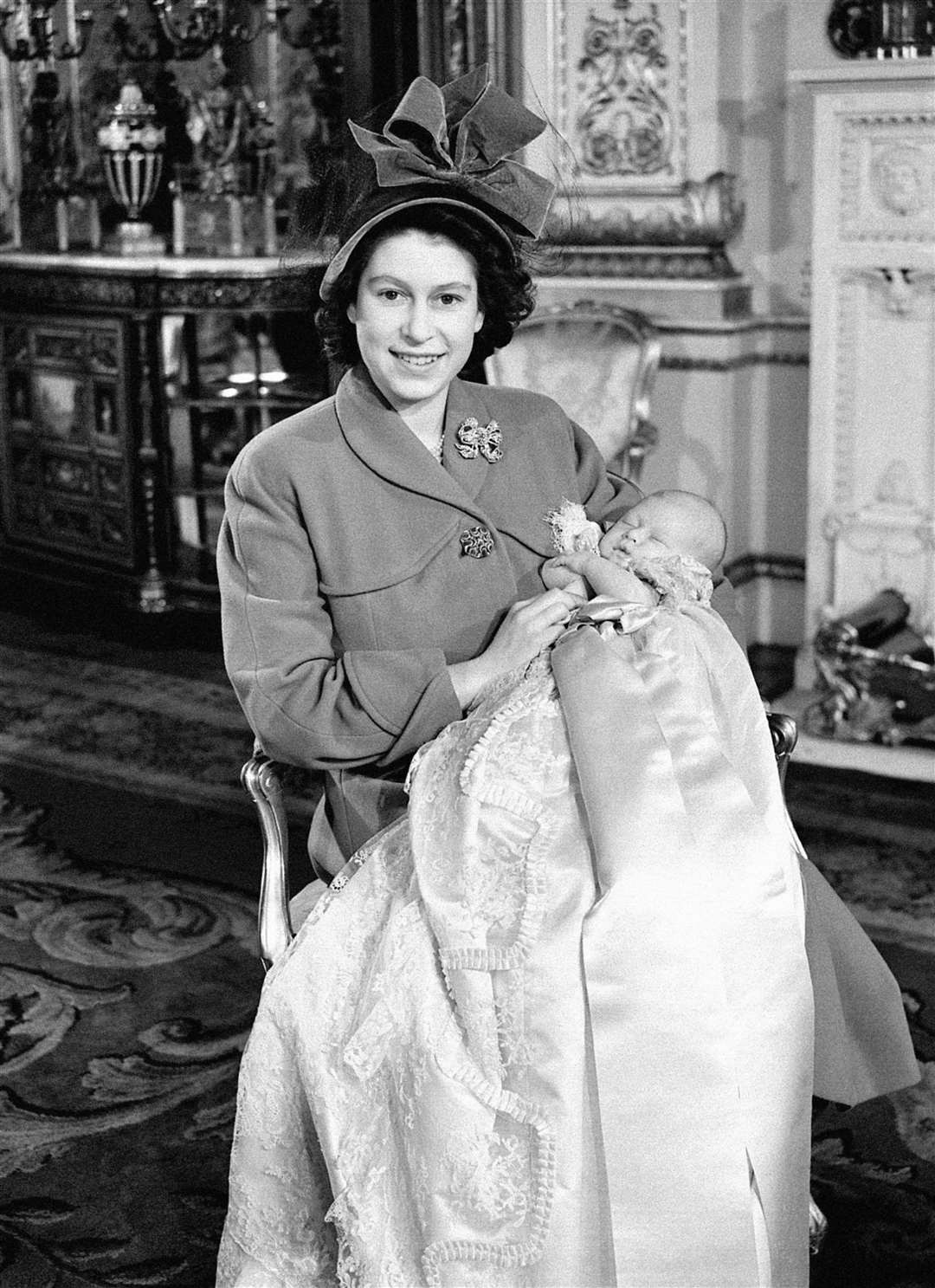 Princess Elizabeth holding Charles, the month before she contracted measles (PA)