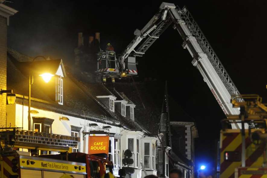 Firefighters tackle the blaze from above. Picture: Paul Amos