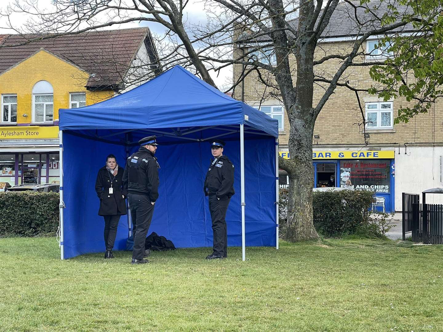 Police officers in the tent near the floral tributes. Picture UKNIP