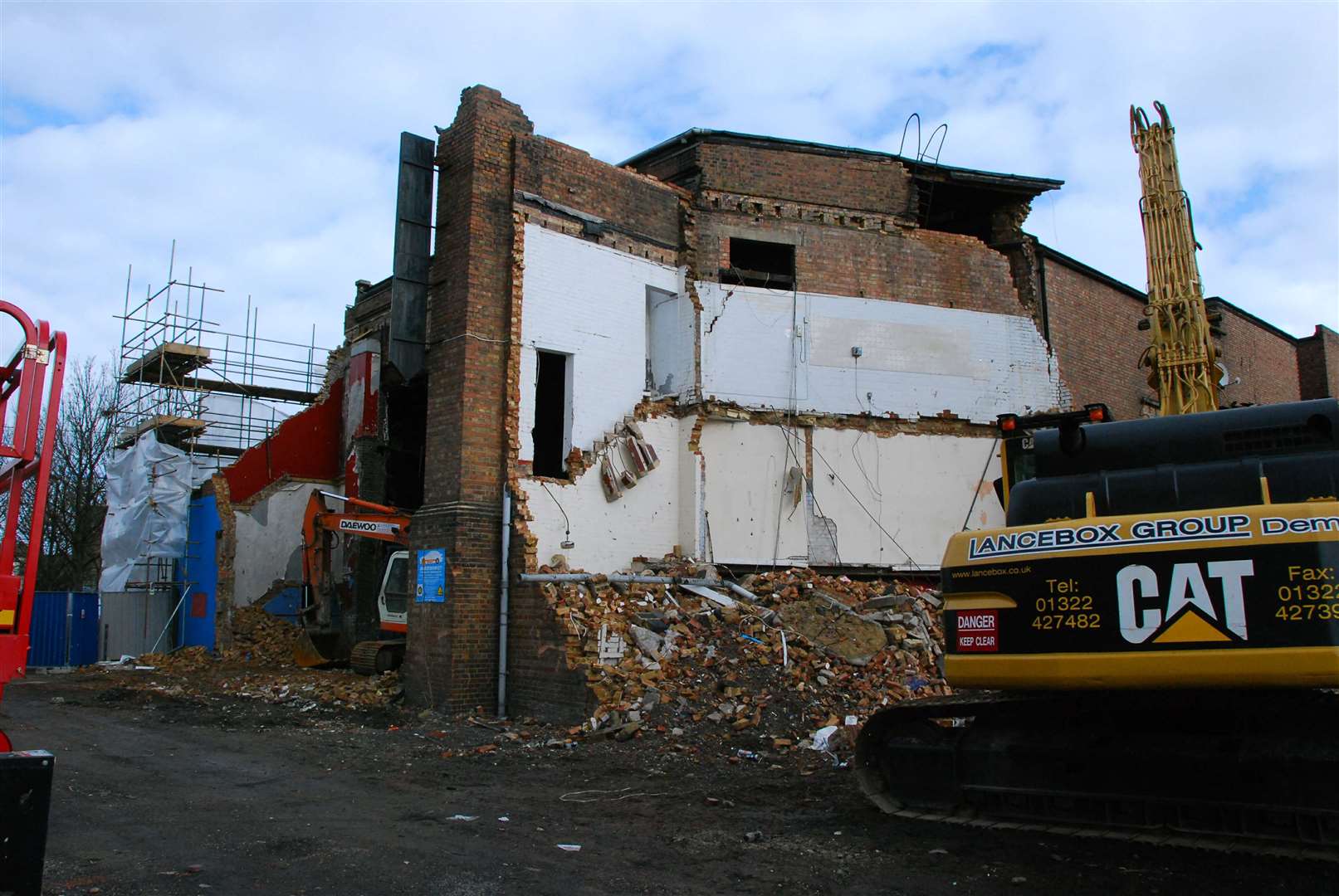 A demolition vehicle prepares to knock down the former Woodies nightclub and cinema in Sheerness