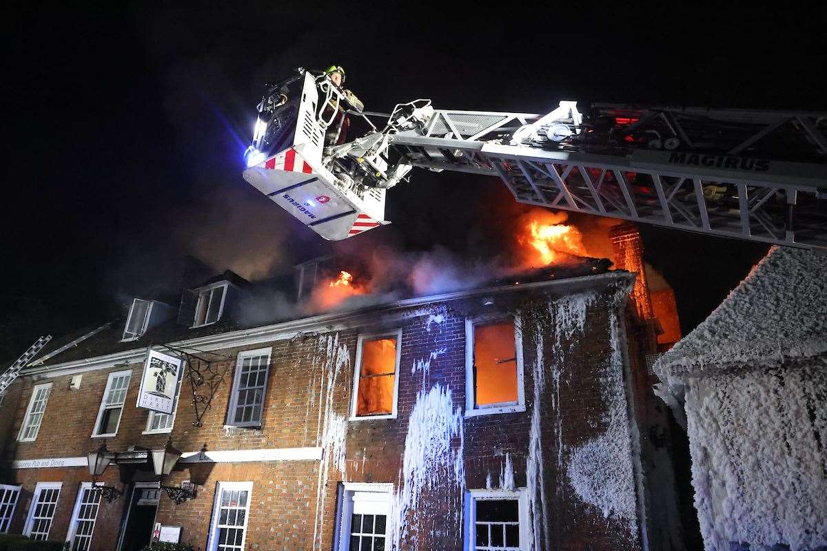 Three fire engines still remain at the scene more than 40 hours after the fire. Picture: UKNip