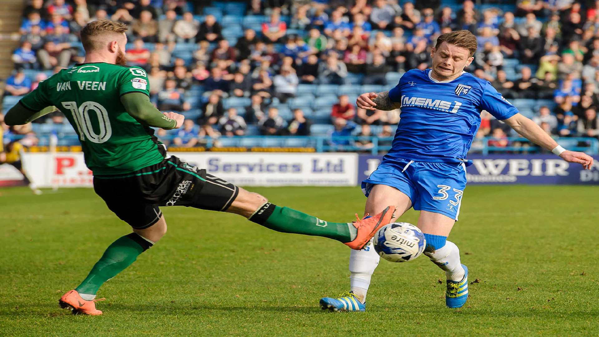 Gillingham's Mark Byrne is challenged by Kevin van Veen. Picture: Andy Payton