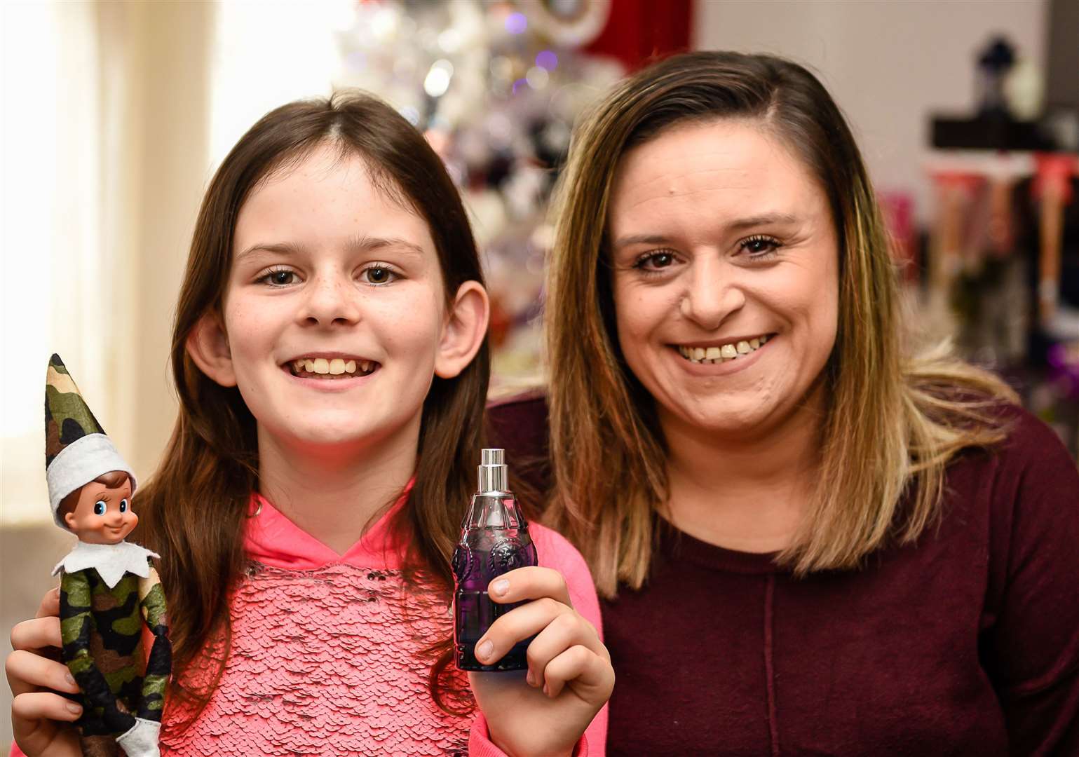 Isabelle Martin and mum Ange with the Army-themed elf and bottle of aftershave gifted to them. Picture: Alan Langley