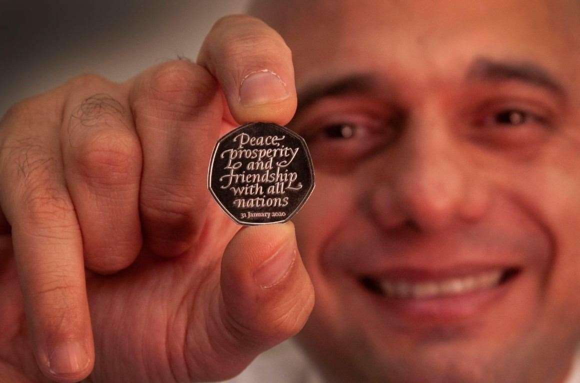 Chancellor of the Exchequer Sajid Javid holding one of the coins
