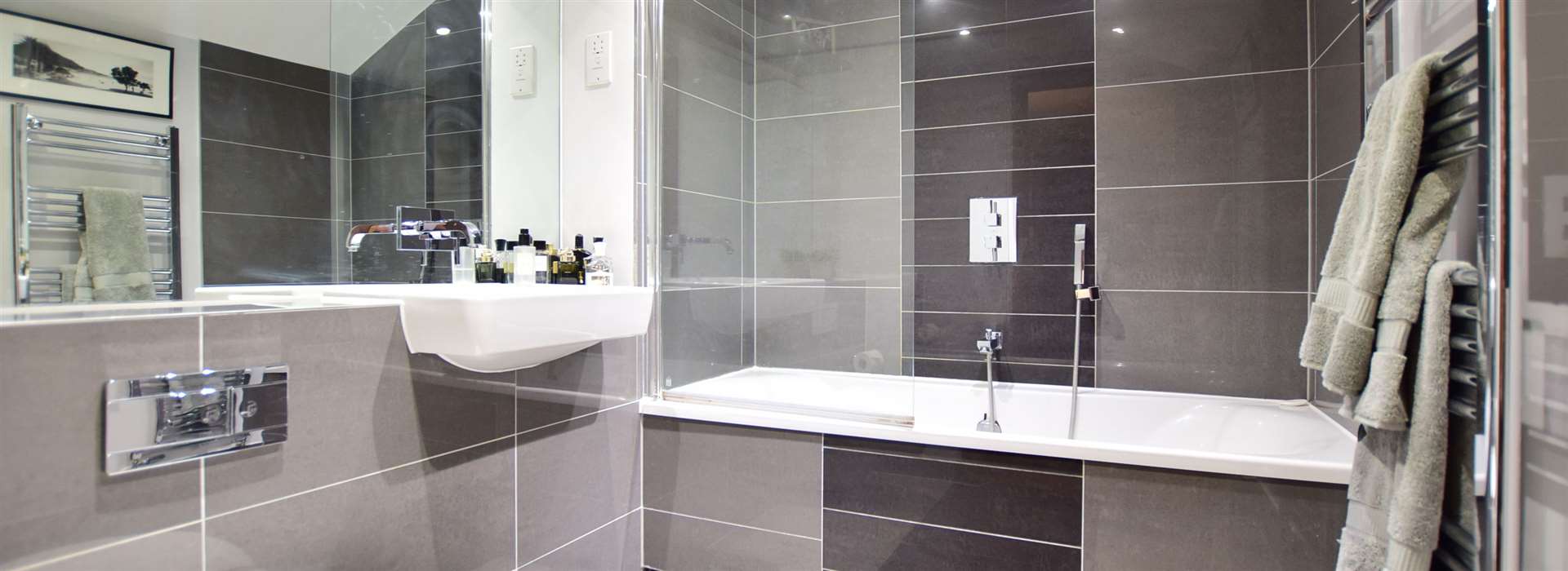 The contemporary bathroom is fully tiled
