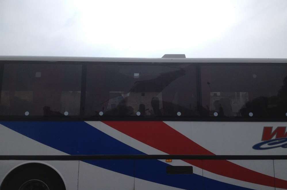 The smashed window of the coach