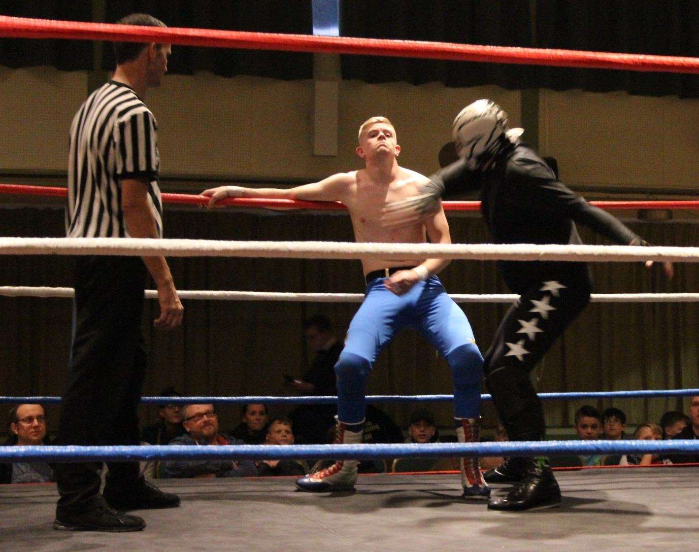 Syd Manelli takes a pounding from the Masked Skull in the quarter-final of Rumble Wrestling's championship bout at Kemsley village hall (6296633)